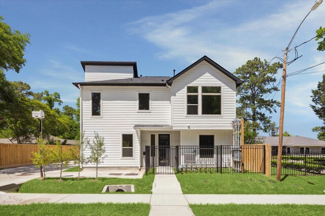 540 Janisch Rd Unit F, Houston, TX 77018 - view of front of property featuring a fenced front yard, a patio area, and a front yard