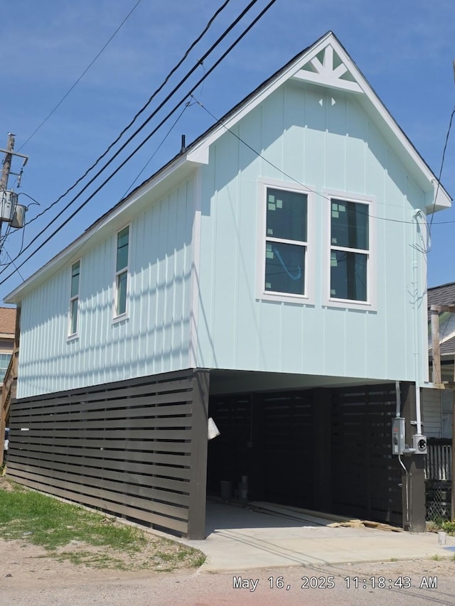 1411 30th St, Galveston, TX 77550 - view of front of home with a carport and board and batten siding