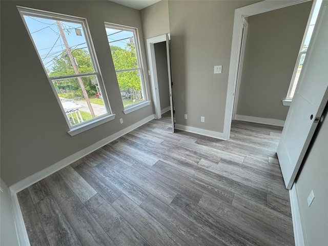 1411 30th St, Galveston, TX 77550 - unfurnished bedroom with wood finished floors and baseboards