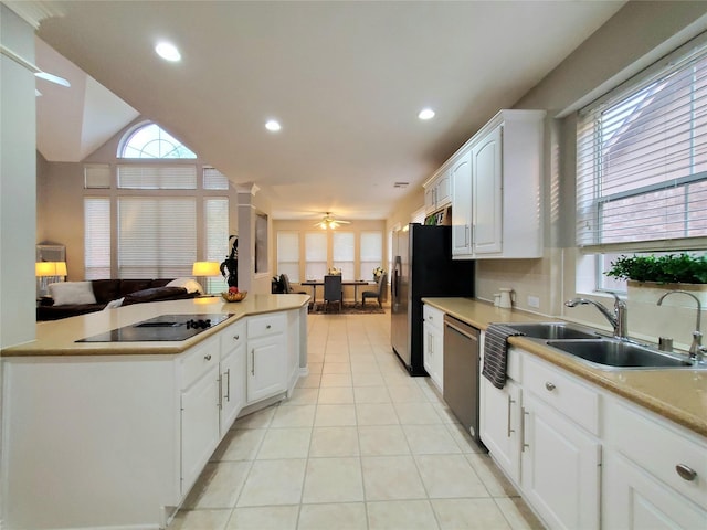 5439 Emerald Pointe Ln, Sugar Land, TX 77479 - kitchen featuring white cabinetry, appliances with stainless steel finishes, light tile patterned floors, and a healthy amount of sunlight