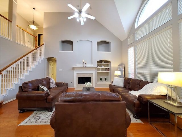 5439 Emerald Pointe Ln, Sugar Land, TX 77479 - living area featuring wood finished floors, high vaulted ceiling, stairway, arched walkways, and a ceiling fan