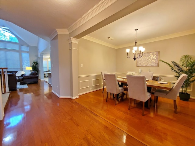 5439 Emerald Pointe Ln, Sugar Land, TX 77479 - dining room featuring crown molding, wainscoting, wood finished floors, and a chandelier