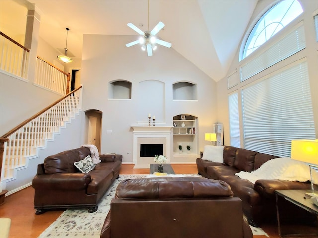 5439 Emerald Pointe Ln, Sugar Land, TX 77479 - living room with built in features, ceiling fan, high vaulted ceiling, stairway, and arched walkways