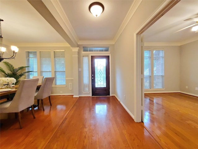 5439 Emerald Pointe Ln, Sugar Land, TX 77479 - foyer with ornamental molding, a notable chandelier, wood finished floors, and a wealth of natural light