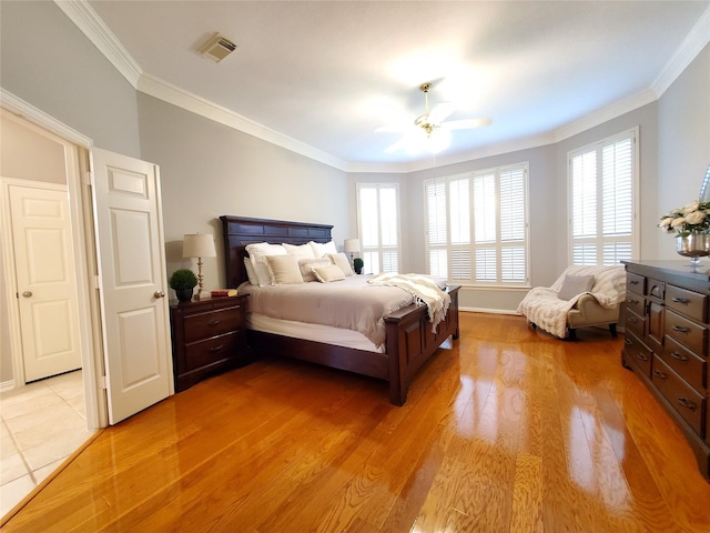 5439 Emerald Pointe Ln, Sugar Land, TX 77479 - bedroom featuring crown molding, visible vents, multiple windows, and light wood-style floors