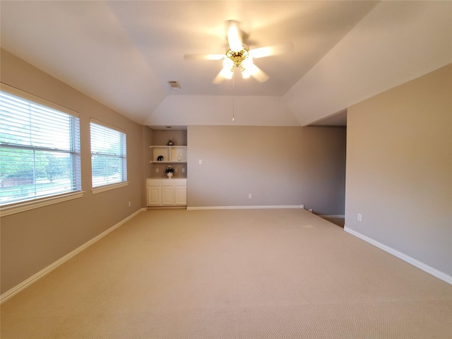5439 Emerald Pointe Ln, Sugar Land, TX 77479 - spare room with visible vents, lofted ceiling, light carpet, built in shelves, and a ceiling fan