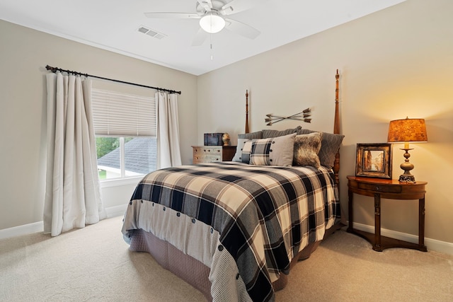 bedroom featuring baseboards, visible vents, and light carpet