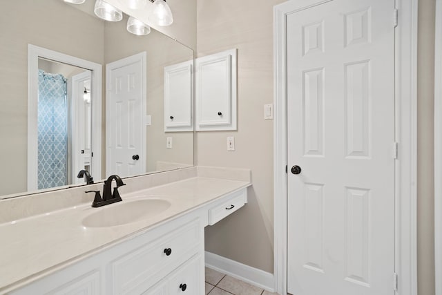 full bath featuring vanity, baseboards, and tile patterned floors