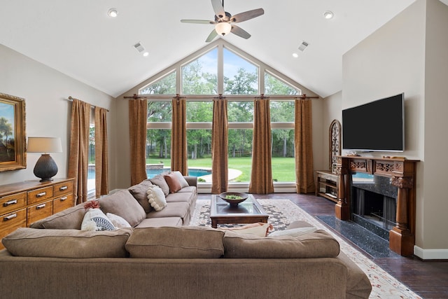 living room with dark wood-style flooring, ceiling fan, visible vents, and high vaulted ceiling