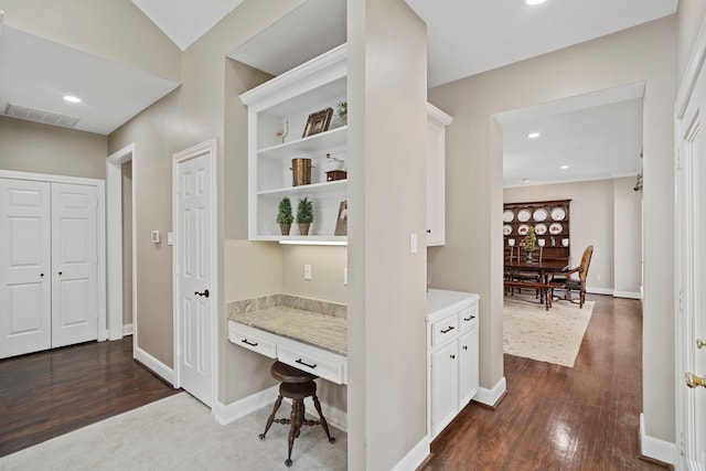 corridor with recessed lighting, dark wood-style floors, and visible vents