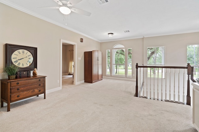 living area featuring ceiling fan, baseboards, an upstairs landing, ornamental molding, and light carpet