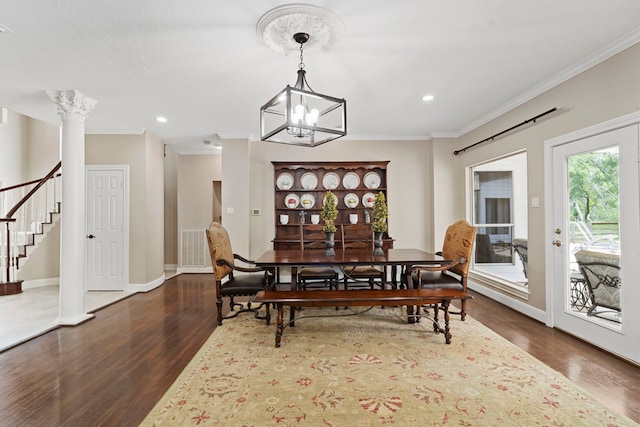 dining area featuring visible vents, ornamental molding, an inviting chandelier, wood finished floors, and stairway