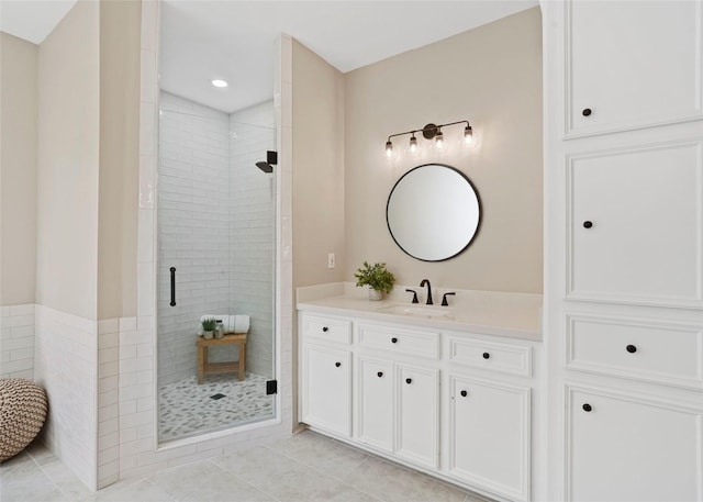 bathroom with vanity, tile patterned flooring, and a stall shower