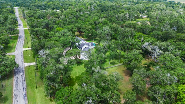 drone / aerial view featuring a view of trees