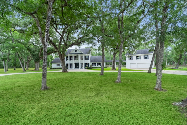 surrounding community featuring a garage, a yard, and driveway