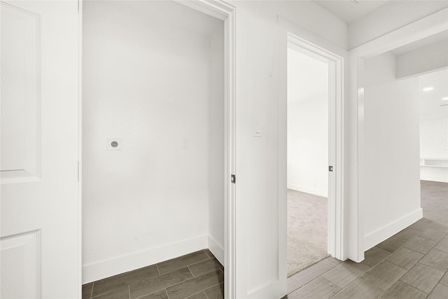 hall with wood finish floors and baseboards