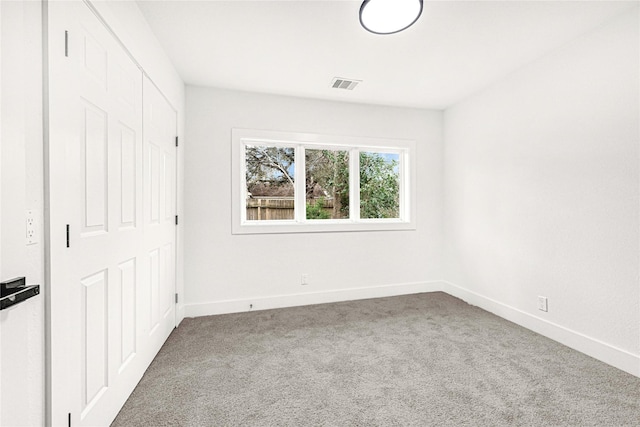 unfurnished bedroom featuring a closet, baseboards, carpet flooring, and visible vents