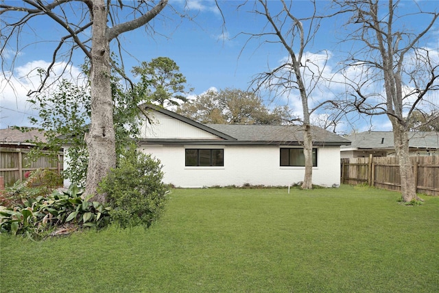 exterior space with a fenced backyard and a yard