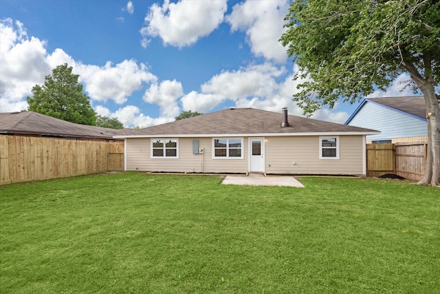rear view of property with a fenced backyard, a patio, and a lawn