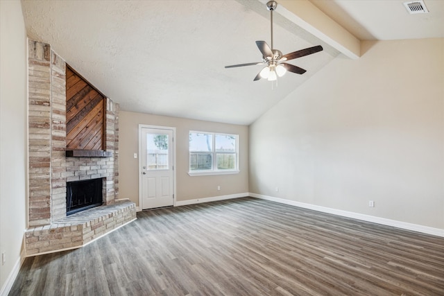 unfurnished living room featuring ceiling fan, a brick fireplace, baseboards, wood finished floors, and visible vents