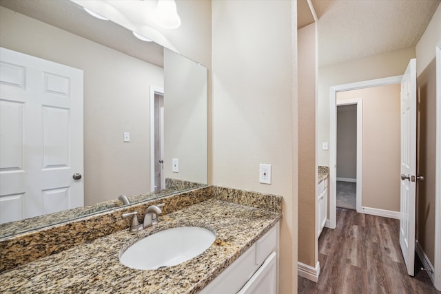 3519 Hombly Rd, Houston, TX 77066 - bathroom featuring wood finished floors, vanity, and baseboards
