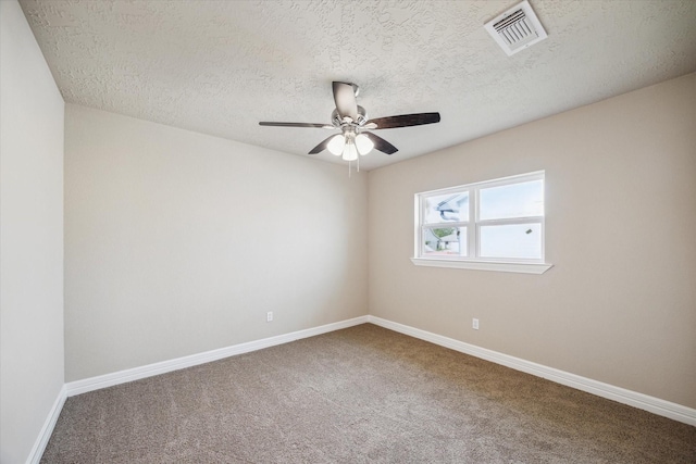 carpeted empty room featuring a ceiling fan, a textured ceiling, visible vents, and baseboards