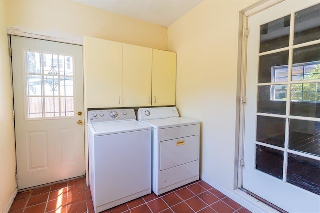 laundry room featuring dark tile patterned flooring, baseboards, cabinet space, and washer and dryer