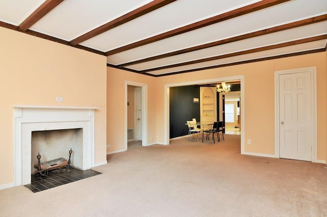 unfurnished living room with carpet flooring, beamed ceiling, a notable chandelier, and baseboards