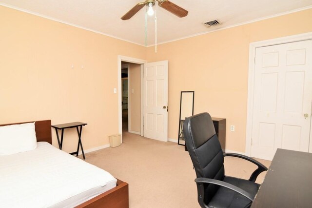 bedroom with crown molding, light colored carpet, baseboards, and visible vents