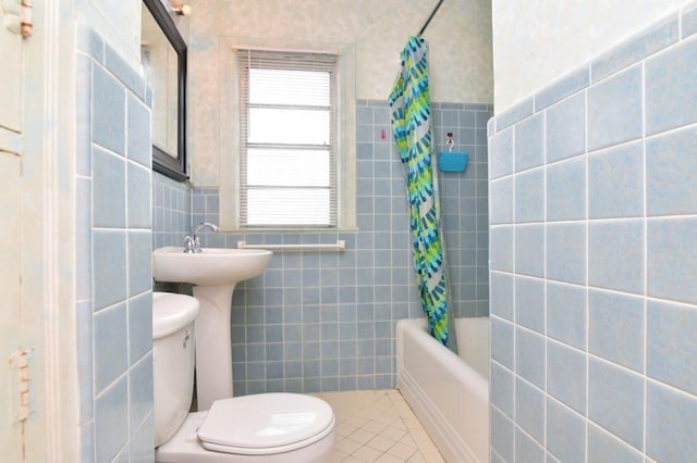 bathroom featuring tile walls, tile patterned flooring, toilet, and shower / tub combo