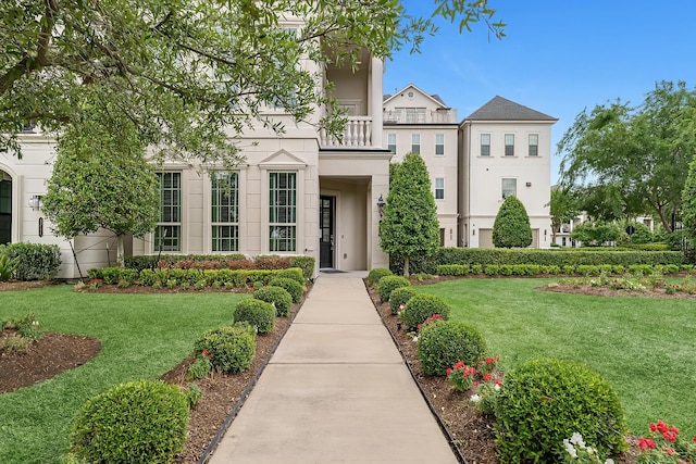 view of front of home with a front lawn and stucco siding