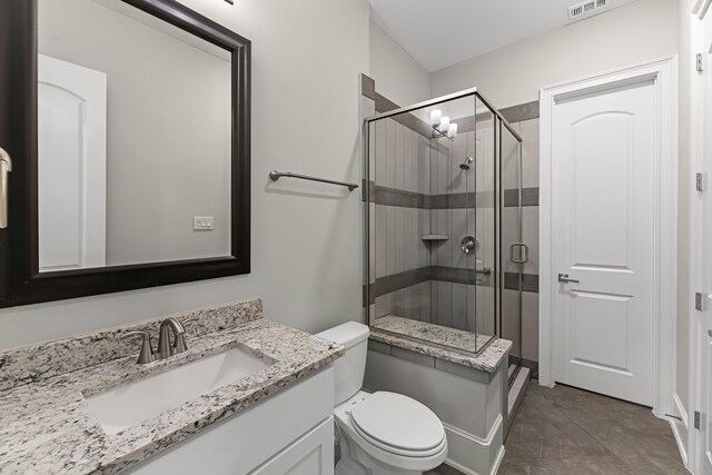 bathroom featuring toilet, visible vents, a shower stall, and vanity