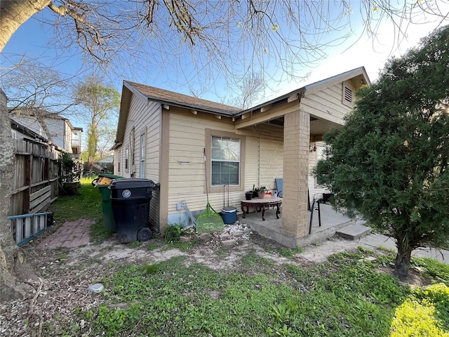 back of house with a patio and fence