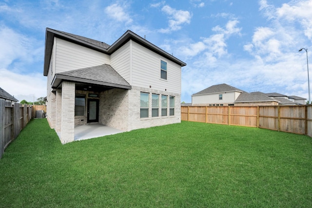 4166 Colony Ln, Missouri City, TX 77459 - back of house with a patio, brick siding, and roof with shingles