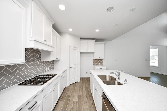 4166 Colony Ln, Missouri City, TX 77459 - kitchen with a sink, gas stovetop, light wood finished floors, light countertops, and recessed lighting