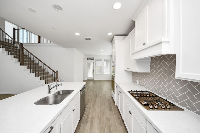 4166 Colony Ln, Missouri City, TX 77459 - kitchen featuring a sink, stainless steel appliances, light countertops, recessed lighting, and backsplash