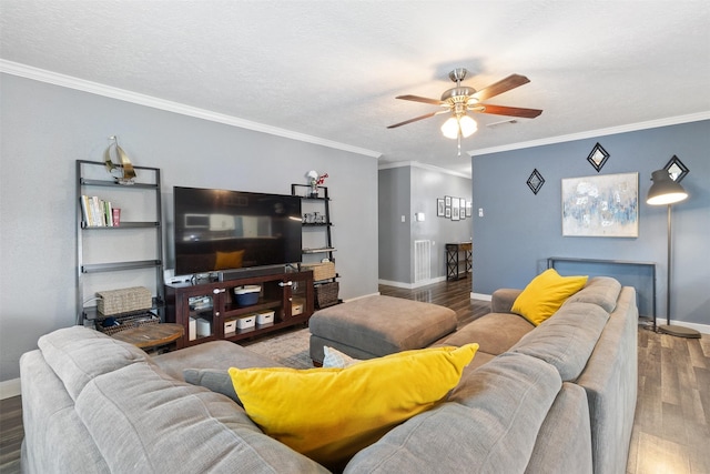 living area featuring baseboards, a ceiling fan, wood finished floors, and ornamental molding