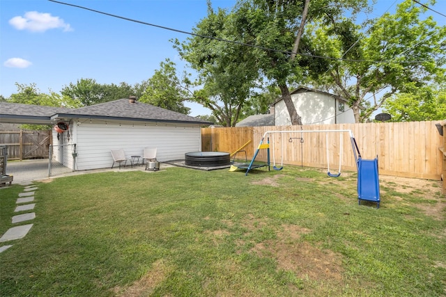 view of yard featuring a fenced backyard, a patio, and a playground