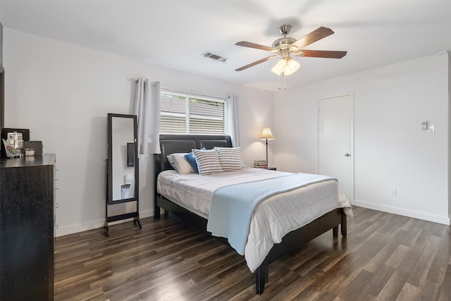 bedroom with baseboards, a ceiling fan, dark wood-style flooring, and visible vents