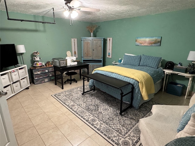 bedroom featuring light tile patterned floors, ceiling fan, and a textured ceiling