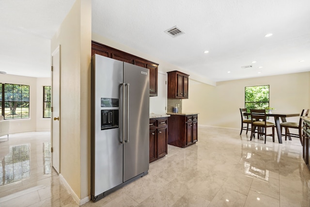 40206 Colfax Rd, Magnolia, TX 77354 - kitchen featuring high end refrigerator, baseboards, dark brown cabinetry, recessed lighting, and light stone countertops