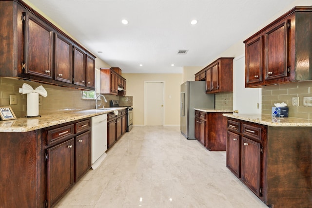 40206 Colfax Rd, Magnolia, TX 77354 - kitchen featuring stainless steel appliances, decorative backsplash, recessed lighting, a sink, and light stone countertops