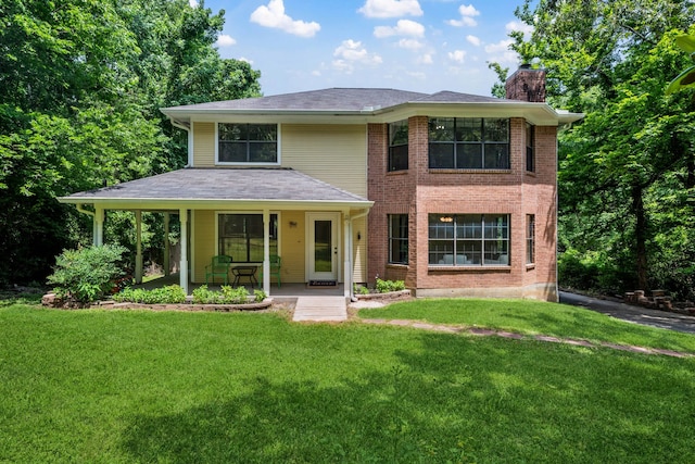 40206 Colfax Rd, Magnolia, TX 77354 - view of front of house featuring a chimney, a front yard, a porch, and brick siding