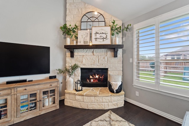 living room featuring a wealth of natural light, a fireplace, wood finished floors, and lofted ceiling