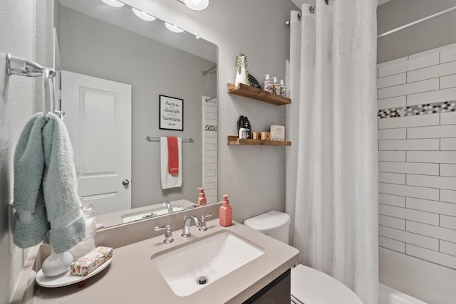 full bathroom featuring vanity, shower / tub combo with curtain, and toilet