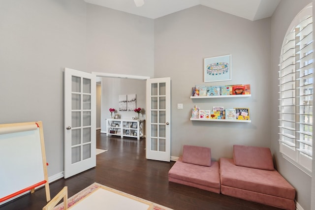 sitting room with baseboards, plenty of natural light, french doors, and wood finished floors