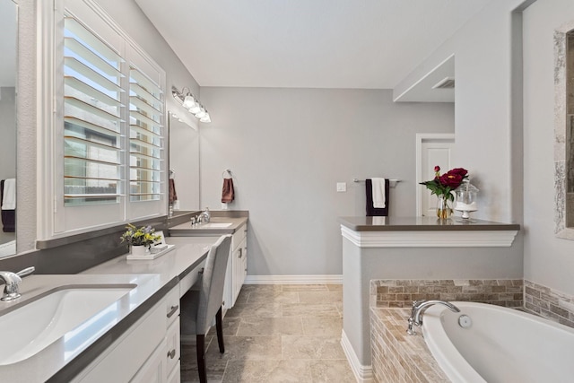 bathroom featuring a sink, a bath, double vanity, and visible vents