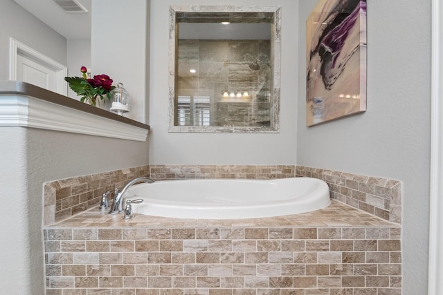 full bath featuring visible vents, a tile shower, and a garden tub