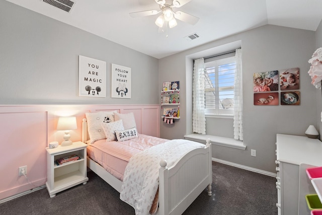 bedroom with ceiling fan, lofted ceiling, dark colored carpet, and visible vents