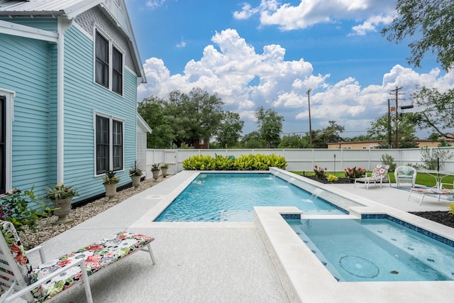 view of pool with a fenced backyard, a patio area, and a pool with connected hot tub